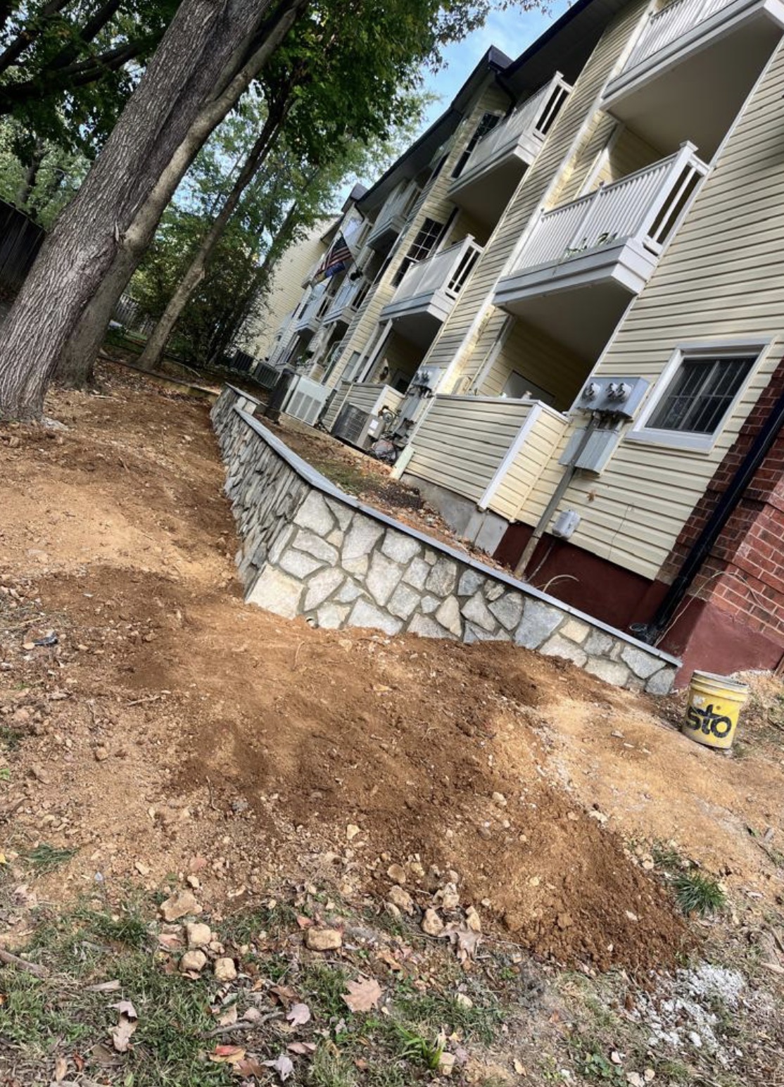 Stone retaining wall near apartment buildings
