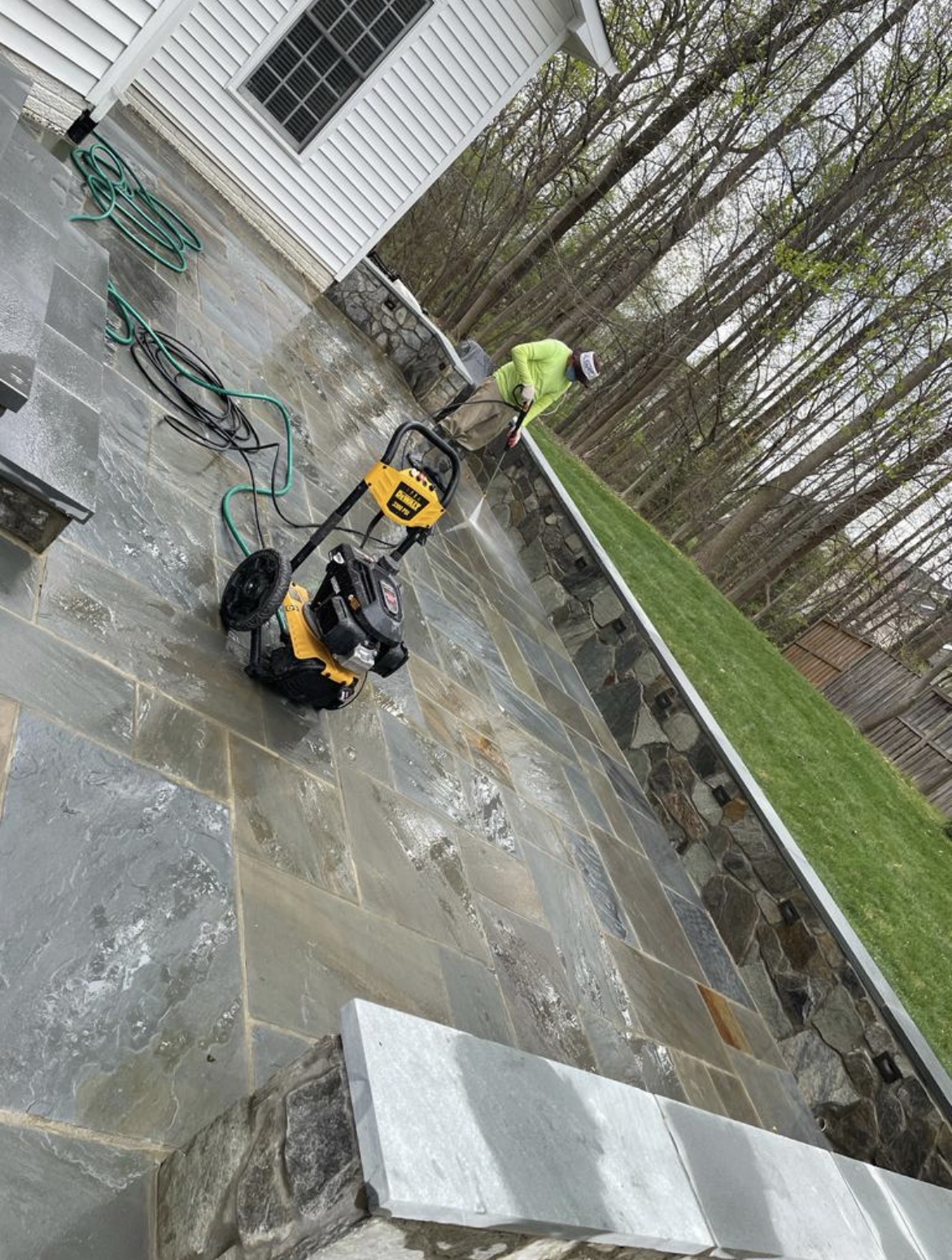 Masonry patio surface being cleaned and protected
